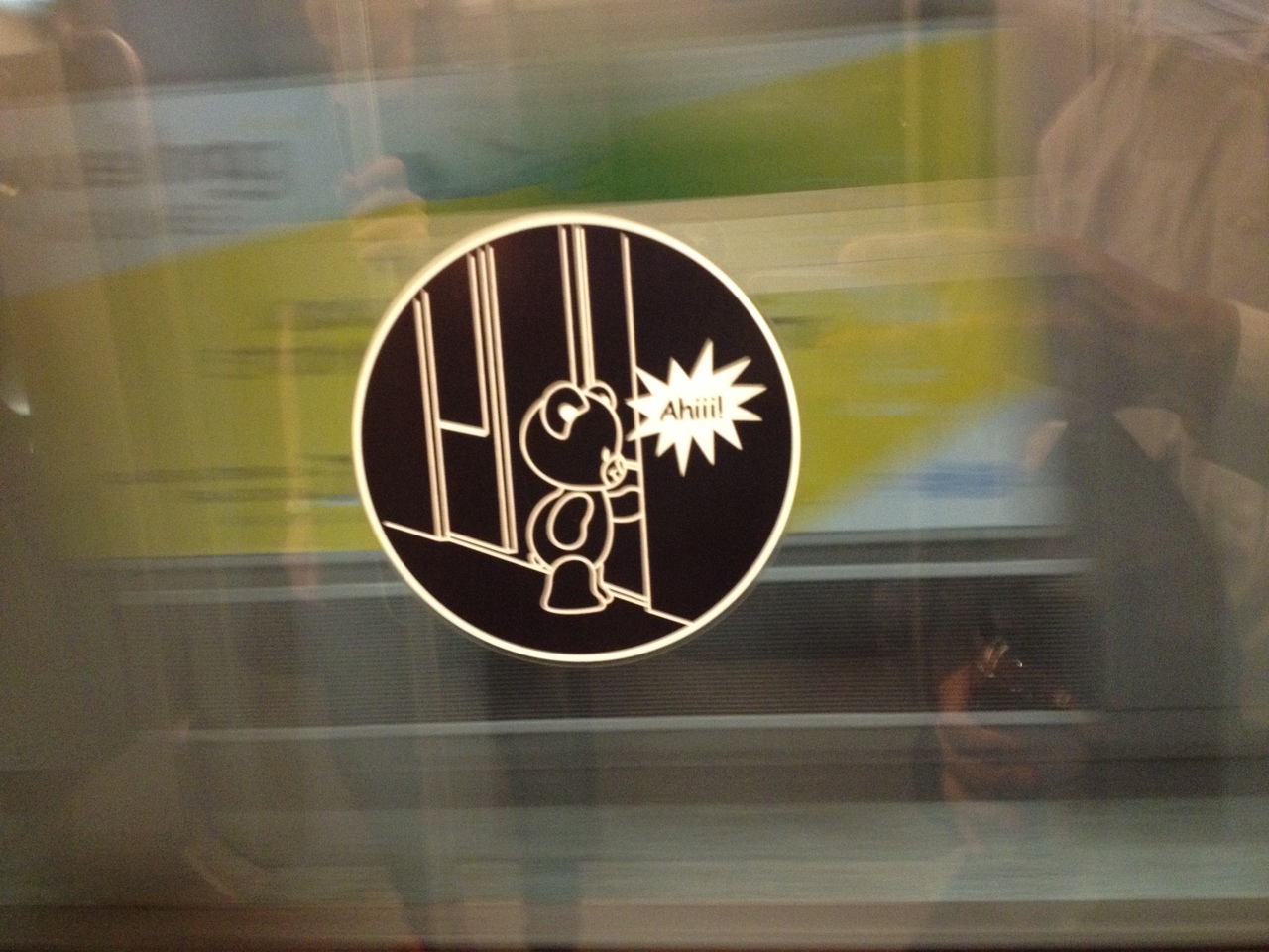 a sticker for not to stick hand between doors