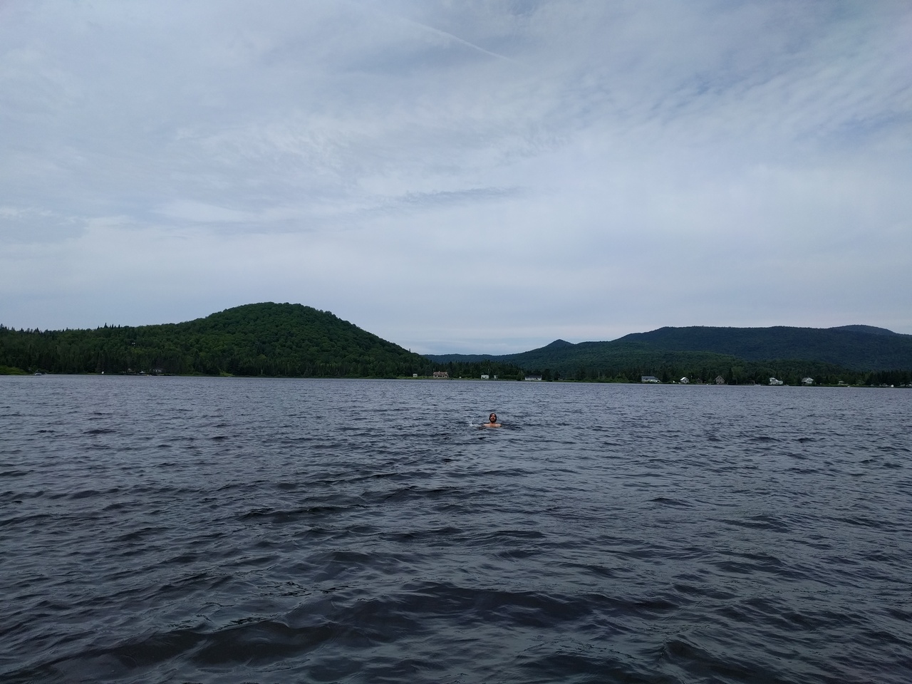 a lake next to a cottage